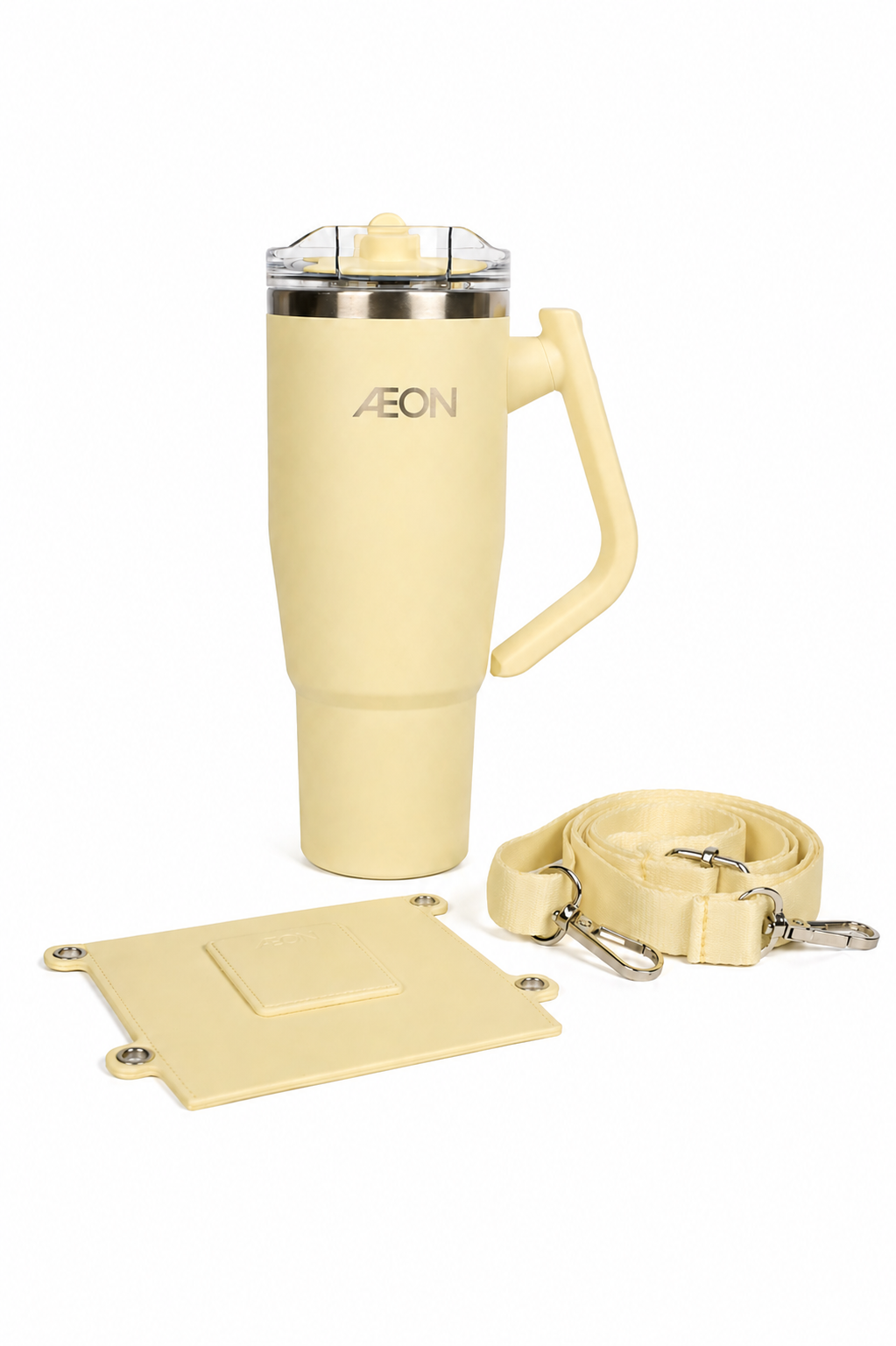 Cream-colored travel mug with handle, keychain, and coaster on a white background