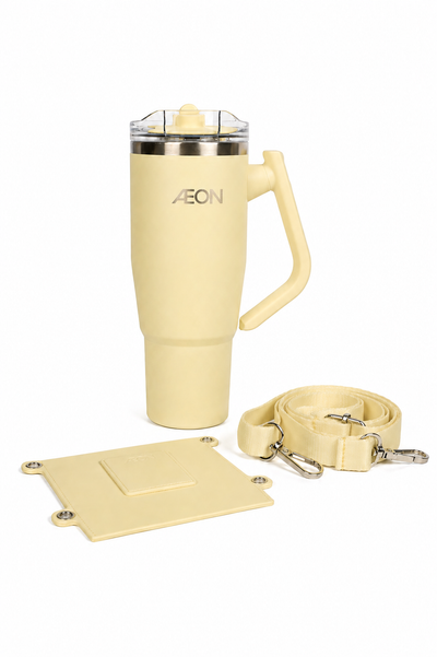 Cream-colored travel mug with handle, keychain, and coaster on a white background